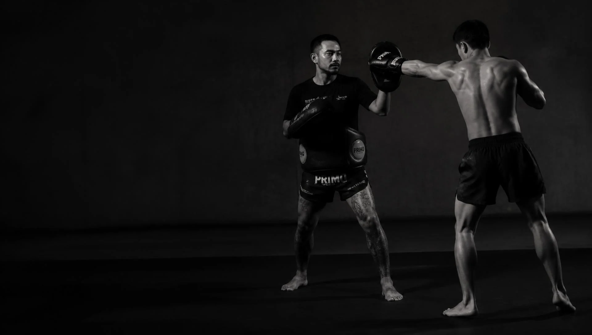 Erick Sampaio treinando um aluno de Muay Thai com aparadores